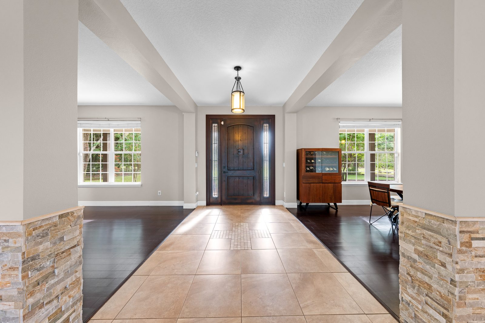 Entry with Old World wood door and stone columns
