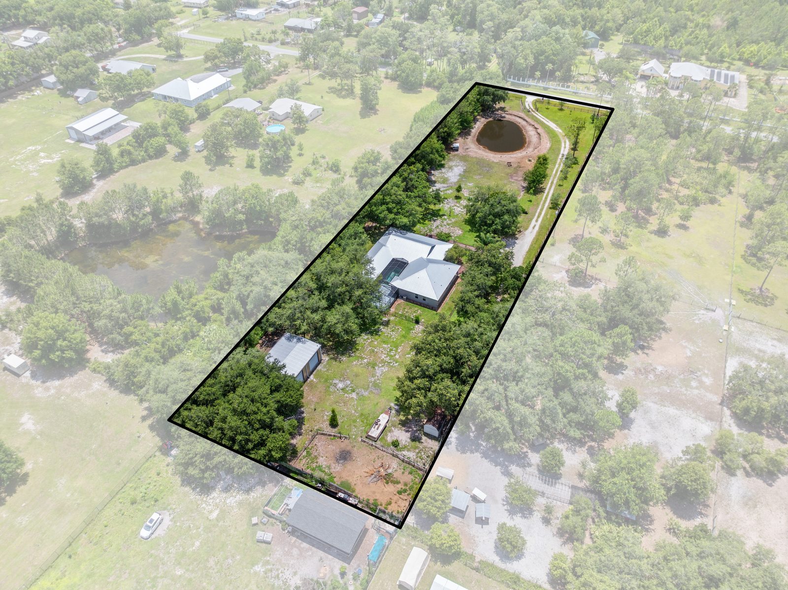 Aerial showing the 2.44-acre fenced lot