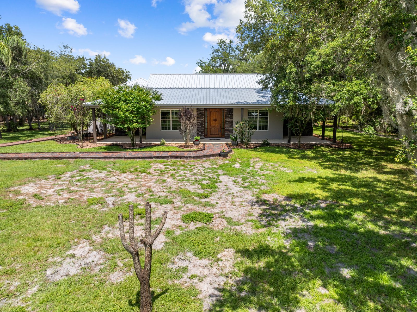 Aerial of the home among mature oaks